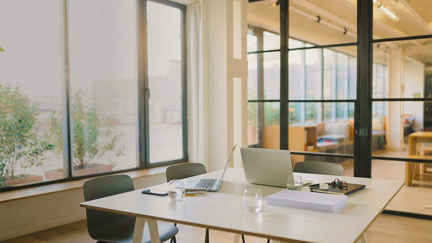 Cozy co-work space with open laptop and natural light