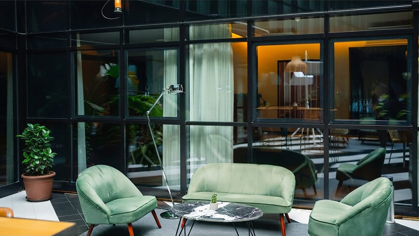 Open conference room with warm wood and lots of greenery
